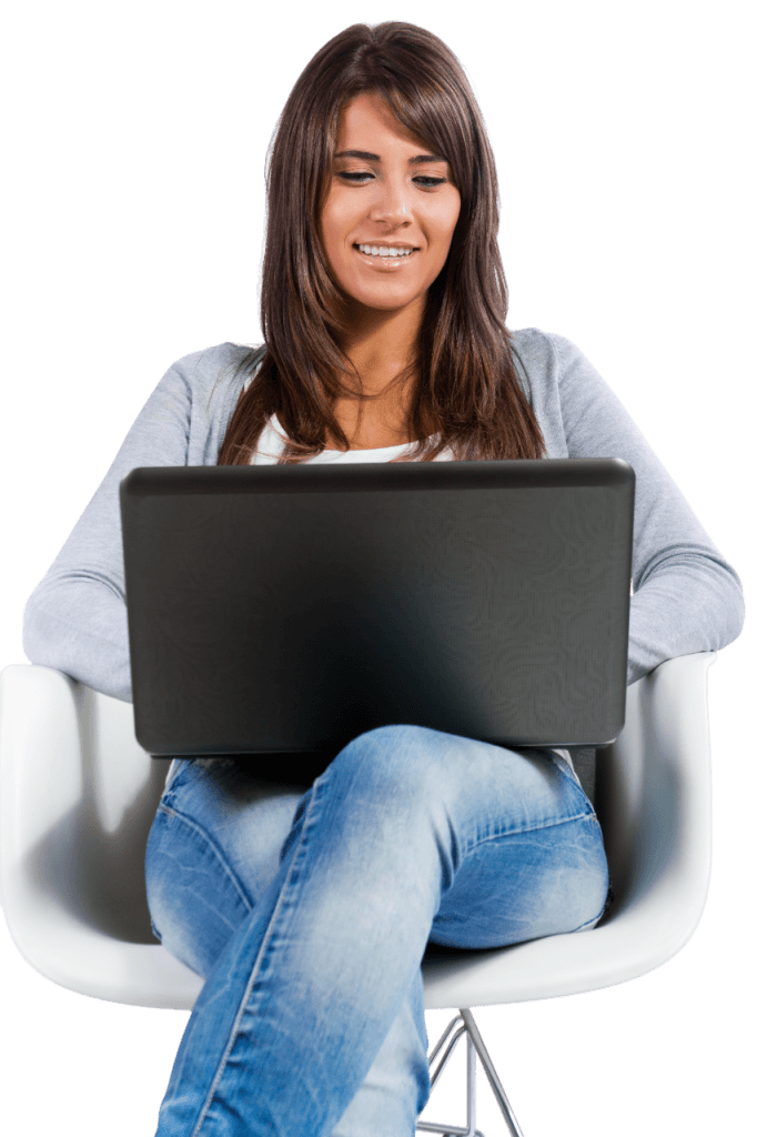 A professional woman comfortably sitting in an ergonomic chair, diligently working on a modern laptop computer.